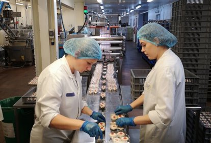 Members of staff inspecting cakes at Bells of Lazonby