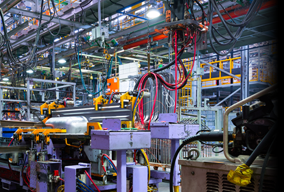 Image of a group of workers working in an industrial factory