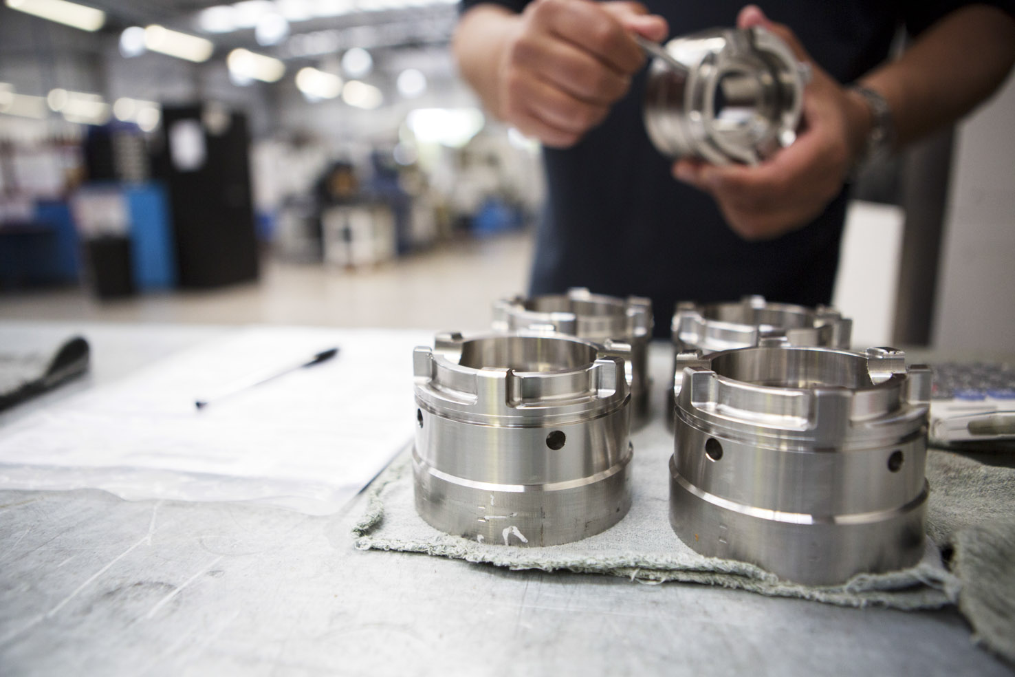 Engineer inspecting machined parts at Beverston Engineering