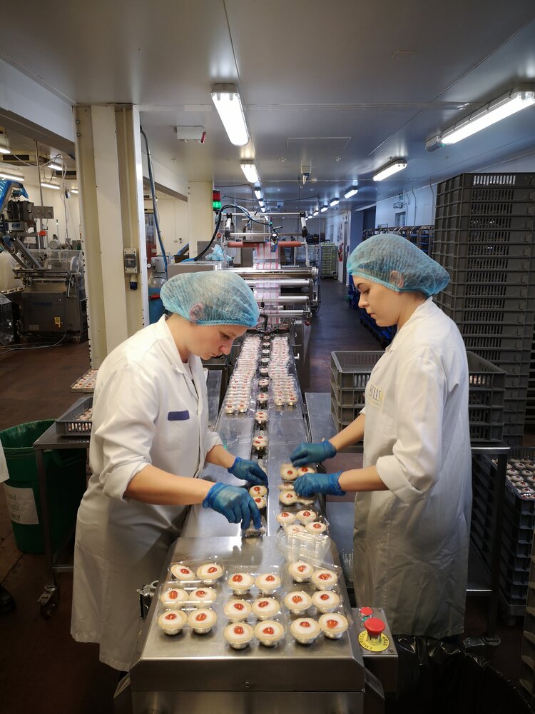 Members of staff inspecting cakes at Bells of Lazonby