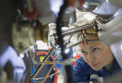 Female helicopter mechanic inspecting wires