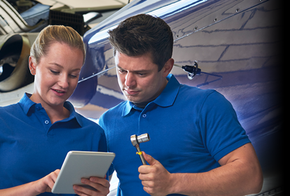 Aero Engineer Working On Helicopter In Hangar