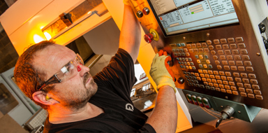 Engineer setting up a machine for production at Fabricon