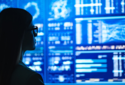 Businesswoman standing near the blue display