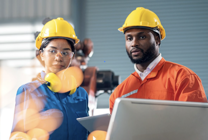 UK manufacturing diversity & inclusion guide - A man and a woman with construction hats working on a manufacturing facility.