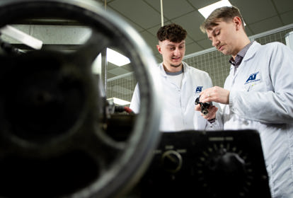 Members of staff discussing finished parts at ATEC Solutions