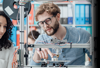 Young engineers operating a 3D printer