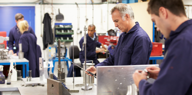 Busy Interior Of Engineering Workshop With Workers