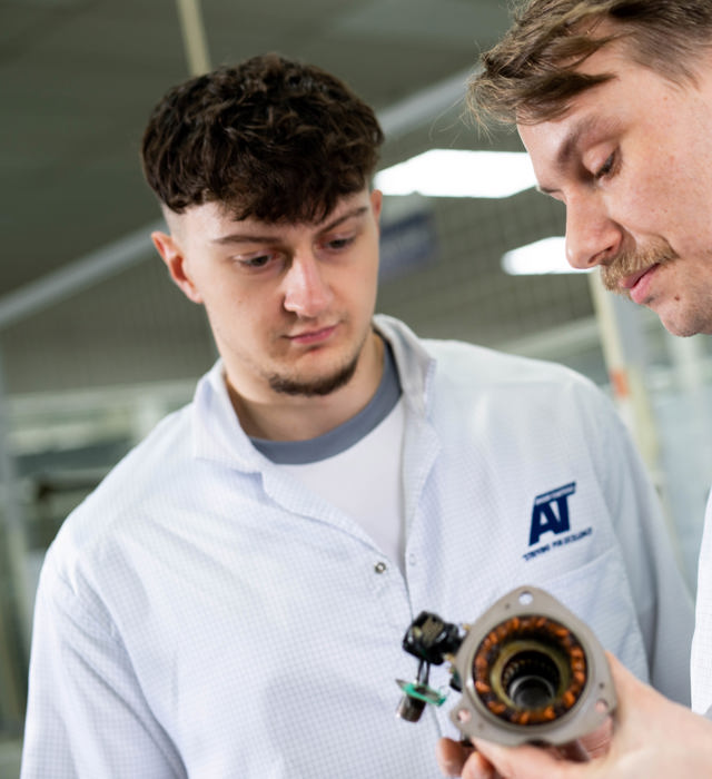 Close up of members of staff discussing finished parts at ATEC Solutions