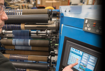 Male engineer setting up an industrial machine for operation using a touchscreen