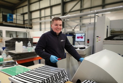 Manufacturer smiling at the camera from Plastic Card Services