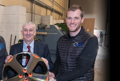 Management Team from DA Techs smiling at the camera with alloy wheel in hand